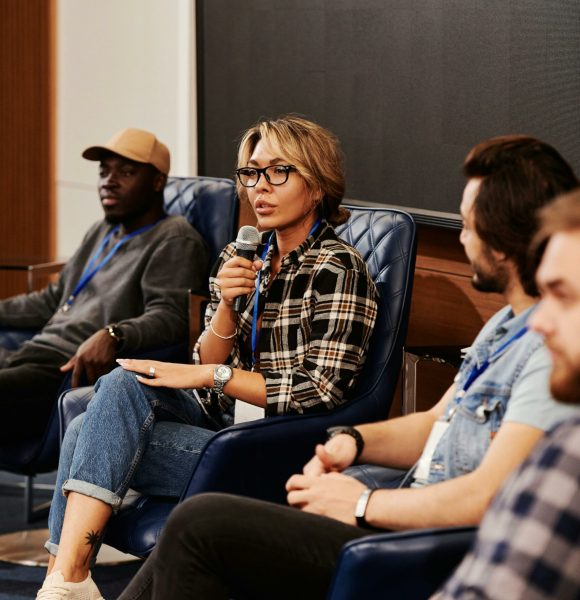 pexels-photo-8344902-8344902-1 A diverse group of adults engaged in a panel discussion during a business seminar. Indoors setting.
